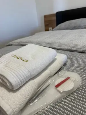 a bed with white towels on top of it at Apartments LESKOVAR in Ormoz