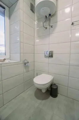 a white bathroom with a toilet and a shower at Apartments LESKOVAR in Ormoz