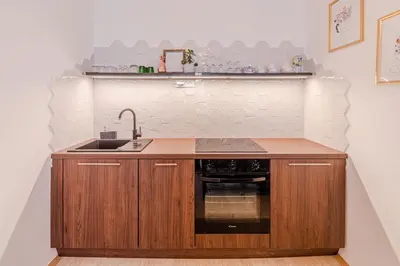 a kitchen with a sink and a stove at Apartment Vandora in Idrija