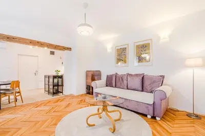 a living room with a purple couch and a table at Apartment Vandora in Idrija