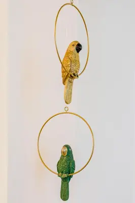 two birds on a hoop hanging on a wall at Apartment Vandora in Idrija