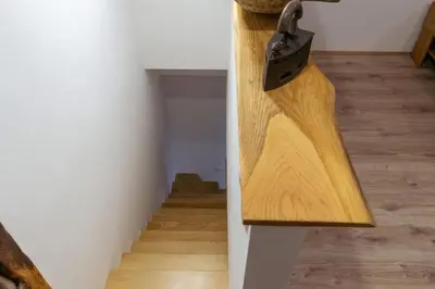 a knife hanging on a wall next to a staircase at Apartma EVA in Ormoz
