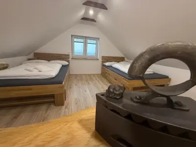 a room with two beds and a statue in the middle at Apartma EVA in Ormoz
