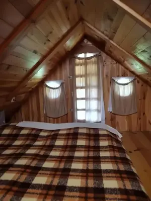 a bedroom with a bed in a attic at Holiday Home Carovina in Paradiž