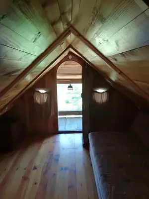 an attic room with a bed and a window at Holiday Home Carovina in Paradiž
