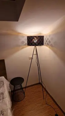 a light on a wall with a table in a room at Apartment Mandi By DIMBIKES in Ajdovščina