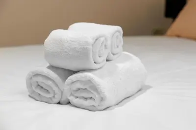 a pile of towels sitting on top of a bed at Apartment Mandi By DIMBIKES in Ajdovščina