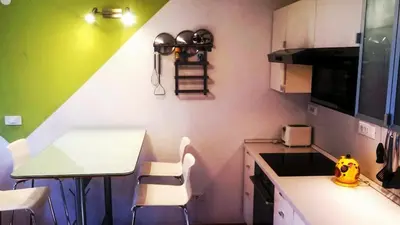 a small kitchen with a table and a counter top at Colorful City Center Apartment - Parking Available in Ljubljana