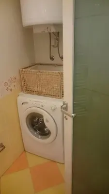 a laundry room with a washing machine in a bathroom at Colorful City Center Apartment - Parking Available in Ljubljana