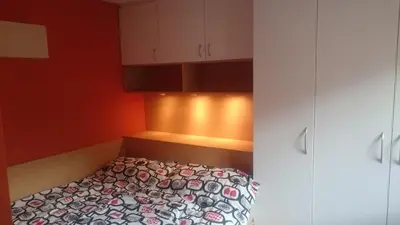 a bedroom with a bed and a white cabinet at Colorful City Center Apartment - Parking Available in Ljubljana
