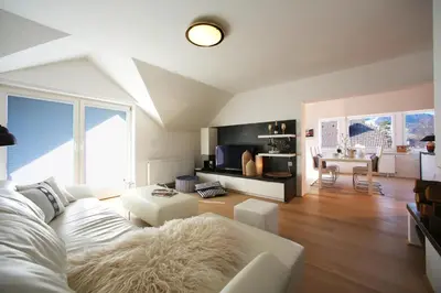 a living room with a white couch and a table at GOLOB Apartment Kranjska Gora in Kranjska Gora