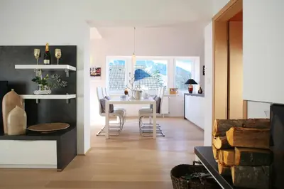 a kitchen and dining room with a table and chairs at GOLOB Apartment Kranjska Gora in Kranjska Gora