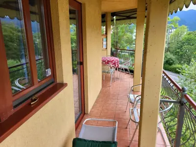 a balcony with a table and chairs on it at Apartment Alpine Lake in Bled
