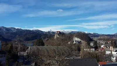 a view of a town with mountains in the background at Apartment Alpine Lake in Bled