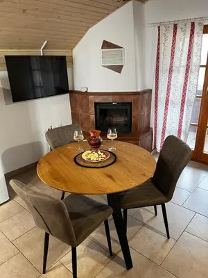 a dining room with a wooden table and chairs at Apartma Zidanca Bele in Dolenjske Toplice