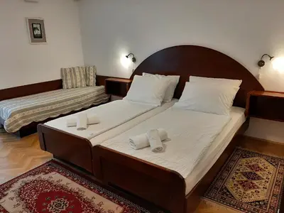 a bedroom with two beds with towels on them at Gostilna Žolnir in Kostanjevica na Krki