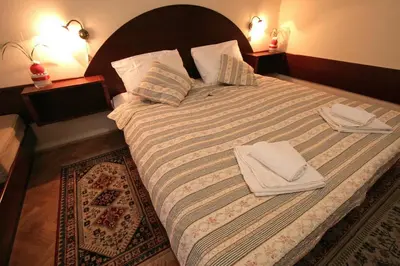 a bedroom with a large bed with two towels on it at Gostilna Žolnir in Kostanjevica na Krki