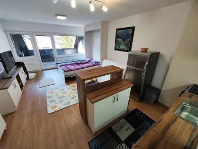 a room with a kitchen with two beds in it at Planica Studio in Kranjska Gora in Kranjska Gora