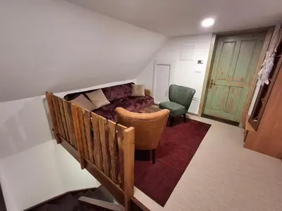a living room with a couch and a chair at Apartma Hiška Vrh in Stari Trg pri Ložu