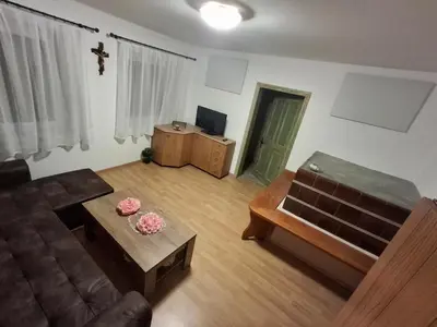 a living room with a couch and a table at Apartma Hiška Vrh in Stari Trg pri Ložu