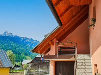 a building with a door and a balcony with plants on it at Apartment Pr' Kavač by Interhome in Rateče