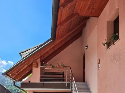 a building with stairs and a balcony with plants at Apartment Pr' Kavač by Interhome in Rateče