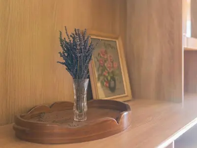 a vase with flowers in it on a wooden table at Apartment Pr' Kavač by Interhome in Rateče