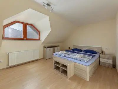 a bedroom with a large bed in a attic at Apartment Pr' Kavač by Interhome in Rateče