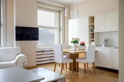 a kitchen and dining room with a table and chairs at Skyscraper Amazing Castle & City View Apartment in Ljubljana