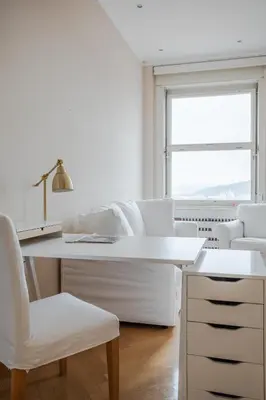 a white office with a desk and white chairs at Skyscraper Amazing Castle & City View Apartment in Ljubljana
