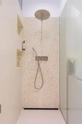 a shower with a shower head in a bathroom at Skyscraper Amazing Castle & City View Apartment in Ljubljana