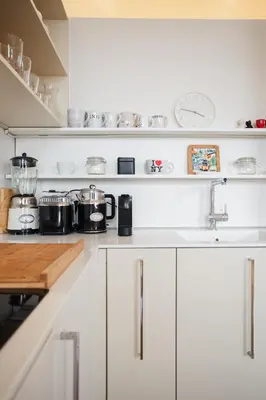a kitchen with white cabinets and a counter top at Skyscraper Amazing Castle & City View Apartment in Ljubljana