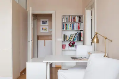 a white dining room with a white table and chairs at Skyscraper Amazing Castle & City View Apartment in Ljubljana