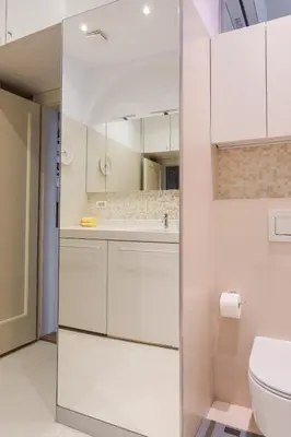 a bathroom with white cabinets and a toilet at Skyscraper Amazing Castle & City View Apartment in Ljubljana