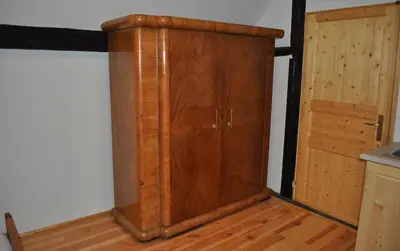 a wooden cabinet in the corner of a room at Apartments Koptur in Škocjan