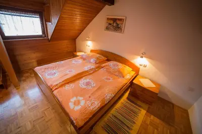 a small bedroom with a bed and a window at Green Garden Apartments Soklič in Bohinj