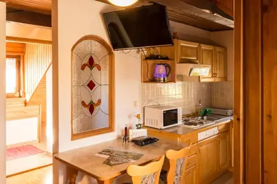 a kitchen with a table and a counter top at Green Garden Apartments Soklič in Bohinj