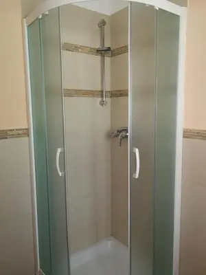 a shower with a glass door in a bathroom at Hiša Kranjc in Kobarid