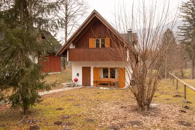 a small house with a red and white at Chalet Fisherman's Cottage in Bohinj