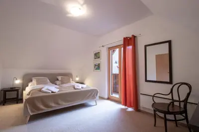 a bedroom with a bed and a window at Chalet Fisherman's Cottage in Bohinj