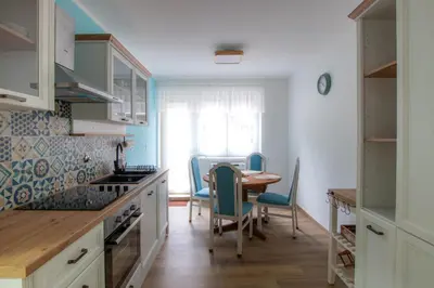 a kitchen with a table and chairs and a dining room at Apartma Rogla Relax in Oplotnica
