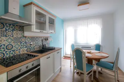 a kitchen with a table and chairs and a dining room at Apartma Rogla Relax in Oplotnica
