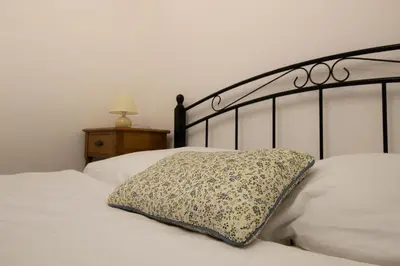 a bed with a pillow sitting on top of it at Apartma Rogla Relax in Oplotnica