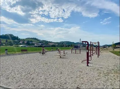 an empty playground with playground equipment in the sand at Spacious Cosy Apt with Pool and Parking in Pesnica pri Mariboru