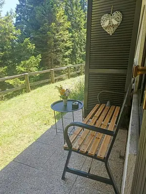 a bench and a table on the side of a house at Studio Queen Alpine in Cerklje na Gorenjskem
