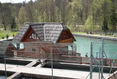 a building in the middle of a body of water at Apartma Mihovc in Kamnik