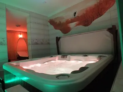 a bath tub with a green light in a bathroom at Apartma Mihovc in Kamnik