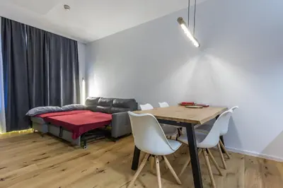 a living room with a table and a couch at Charming A&S Pohorje Apartments in Pohorje