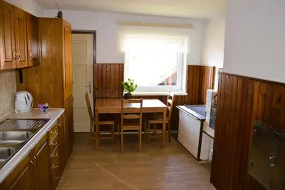 a kitchen with a table and a dining room at Granny Angela's house in Grosuplje