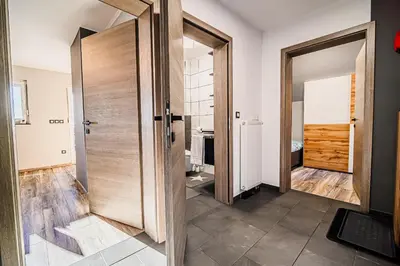 a hallway with a wooden door in a room at Holiday Home Mountainview Horizon with Private Sauna & Hot Tub in Dravograd